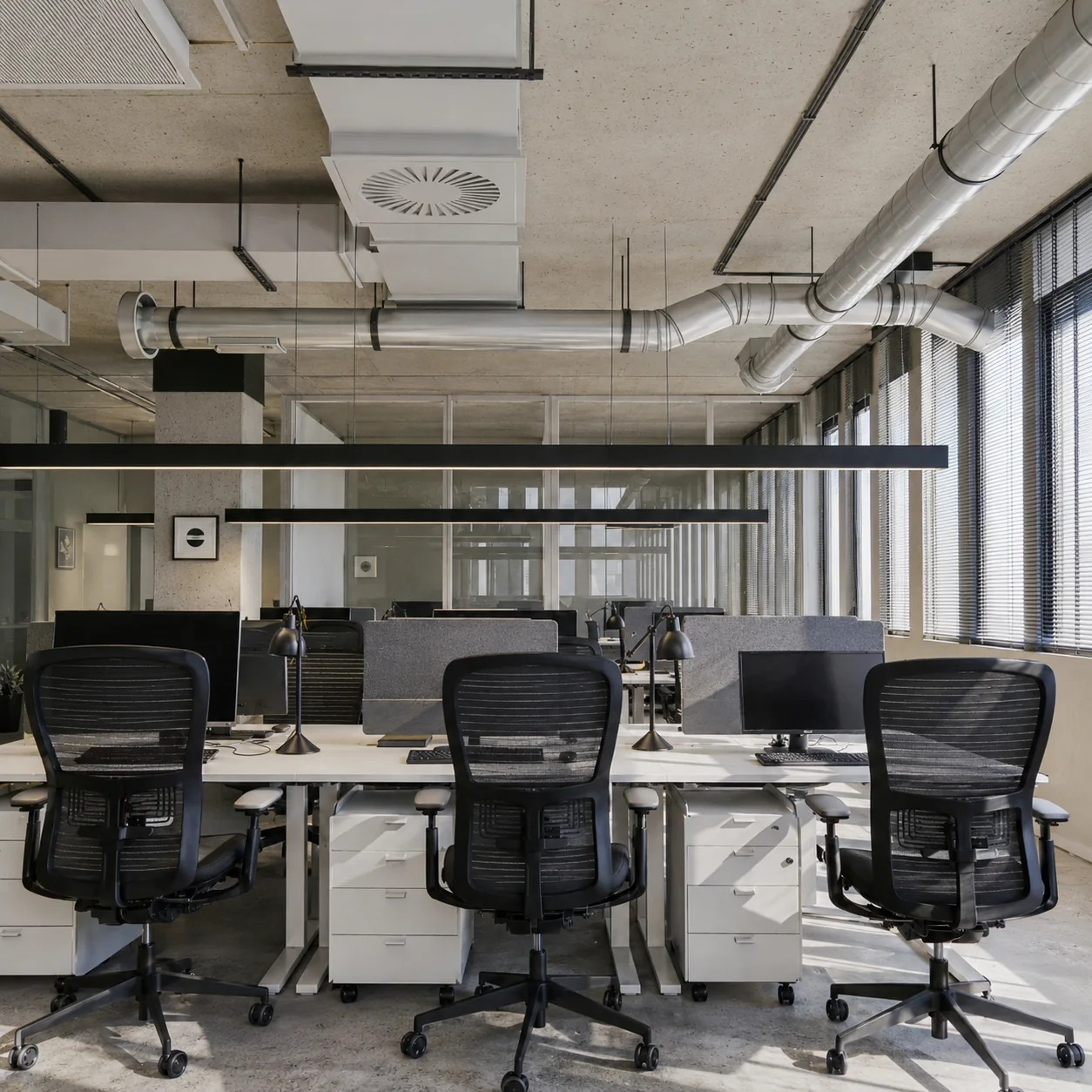Team workspace with exposed concrete and services
